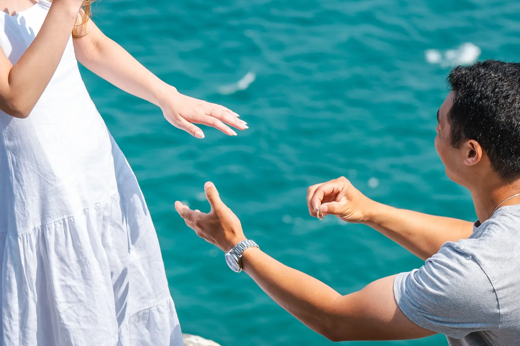 Close-up of two hands reaching toward each other during a proposal, Michelangelo style